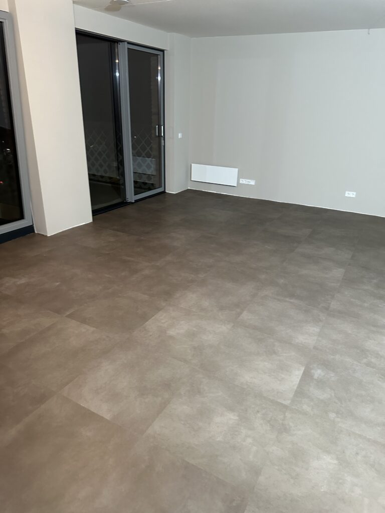Vloertegel Strong taupe PVC vloer van Stile Floors – warme houtlook voor huiselijke ruimtes.